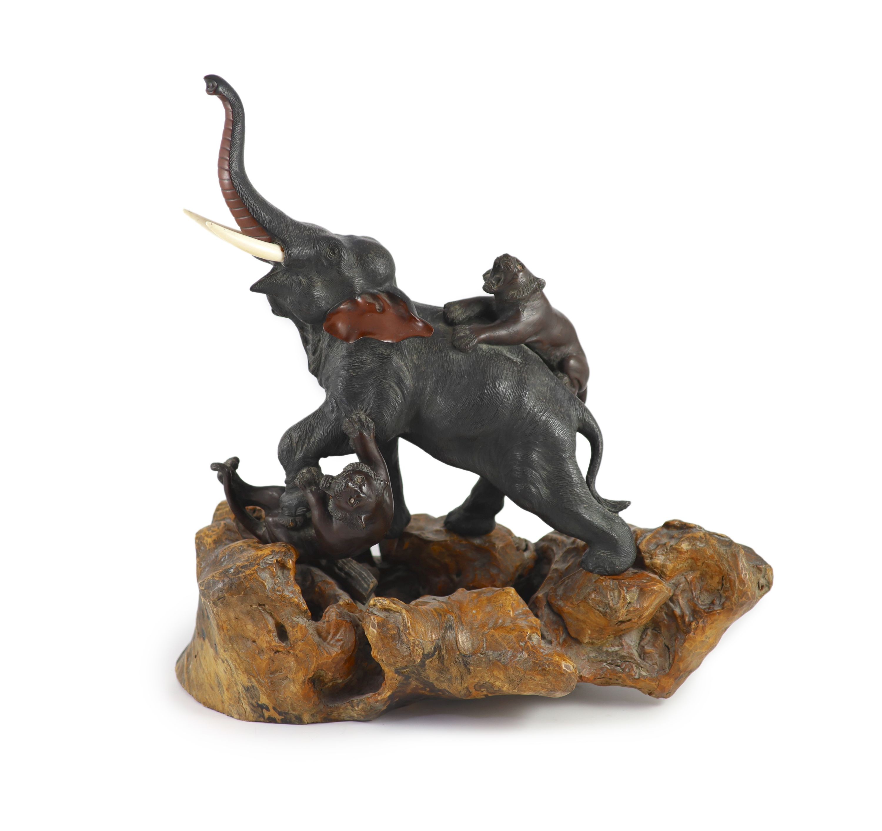 A good Japanese bronze elephant and tiger group, Meiji period signed Seiya saku, Total height 55cm and length 55cm including stand